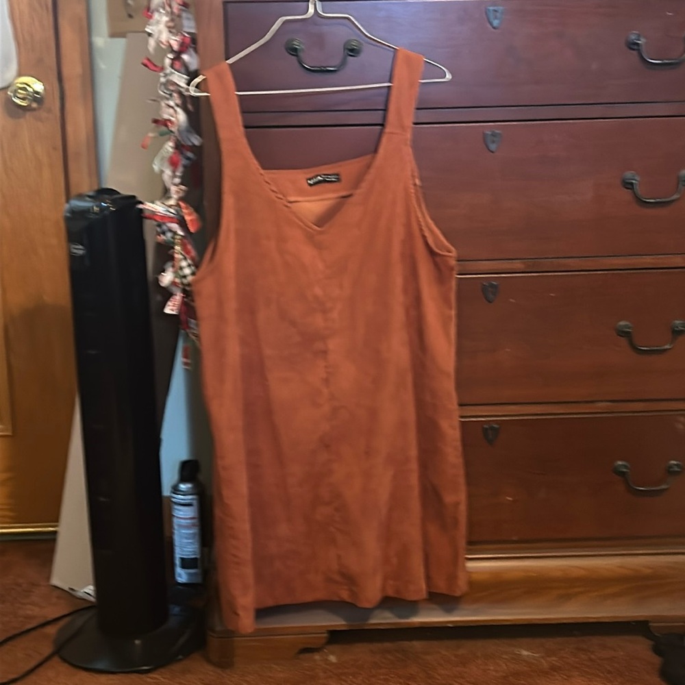 An burgandy orange tank top dress, meant to be worn with a shirt under, short